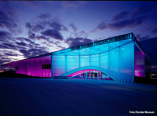 Außenansicht des Dornier Museums in Friedrichshafen, bunt beleuchtet